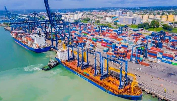 Container ship docked at Port of Dar es Salaam with city skyline, agricultural export logistics Tanzania