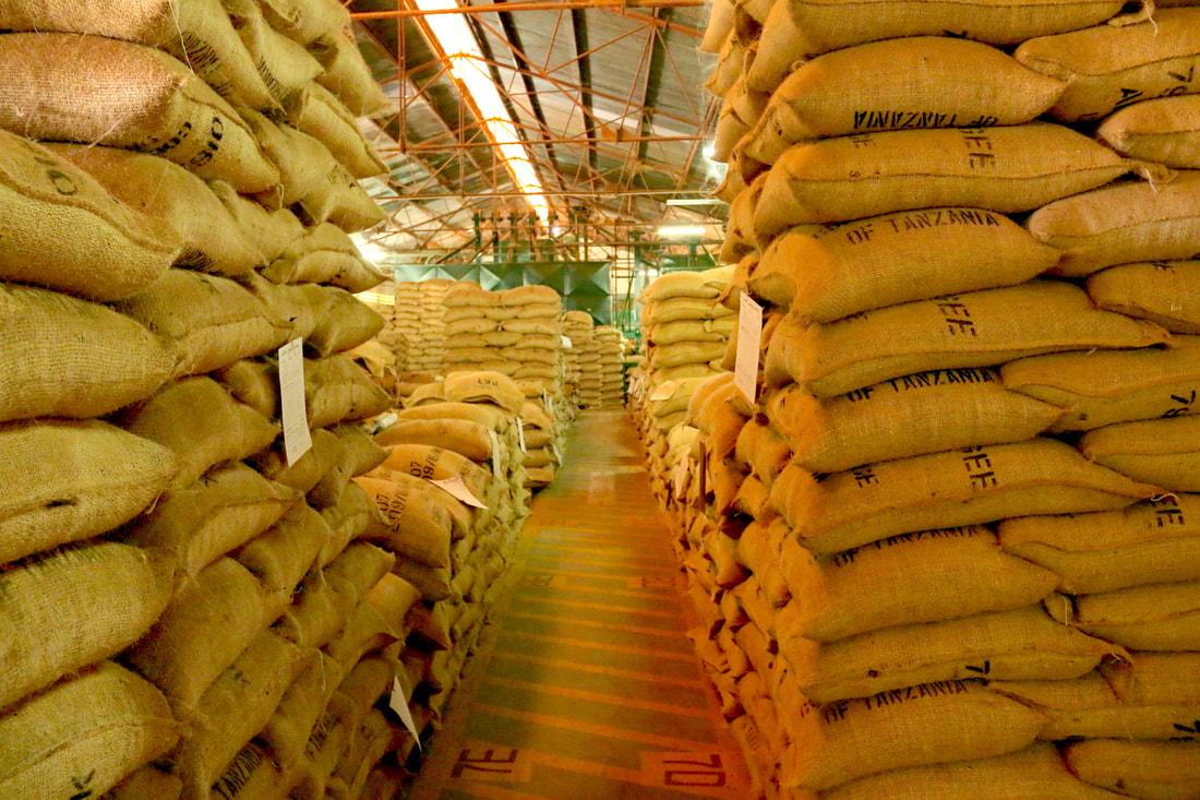 Warehouse interior with rows of stacked commodity sacks for institutional supply in Tanzania, Global Agrichain